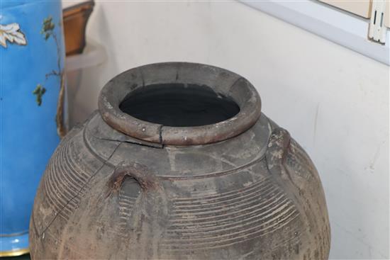 An Egyptian terracotta jar, with four carrying lug handles, Pre-Dynastic, H. 35cm, badly cracked